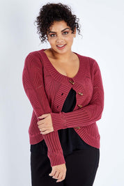 Model Sasha-Lee wearing size XL of the Fireside Button Cardigan in colour Plum (Red), from the front, cropped image