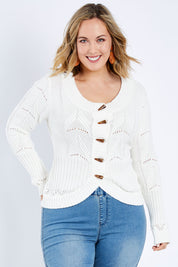 Model Jess wearing size L of the Fireside Button Cardigan in colour Snow (White), from the front, cropped image