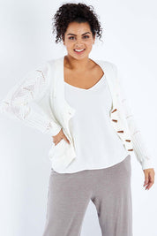 Model Sasha-Lee wearing size XL of the Fireside Button Cardigan in colour Snow (White), from the front, cropped image