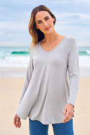 Model Tegan wearing size 10 of the Long Sleeve Softly Swinging Bamboo Tee in colour Greymarle (Grey), from the front, showing the whole outfit