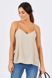 Model Georgia wearing size 10 of the Runaway Top in colour Sand, from the front, cropped image