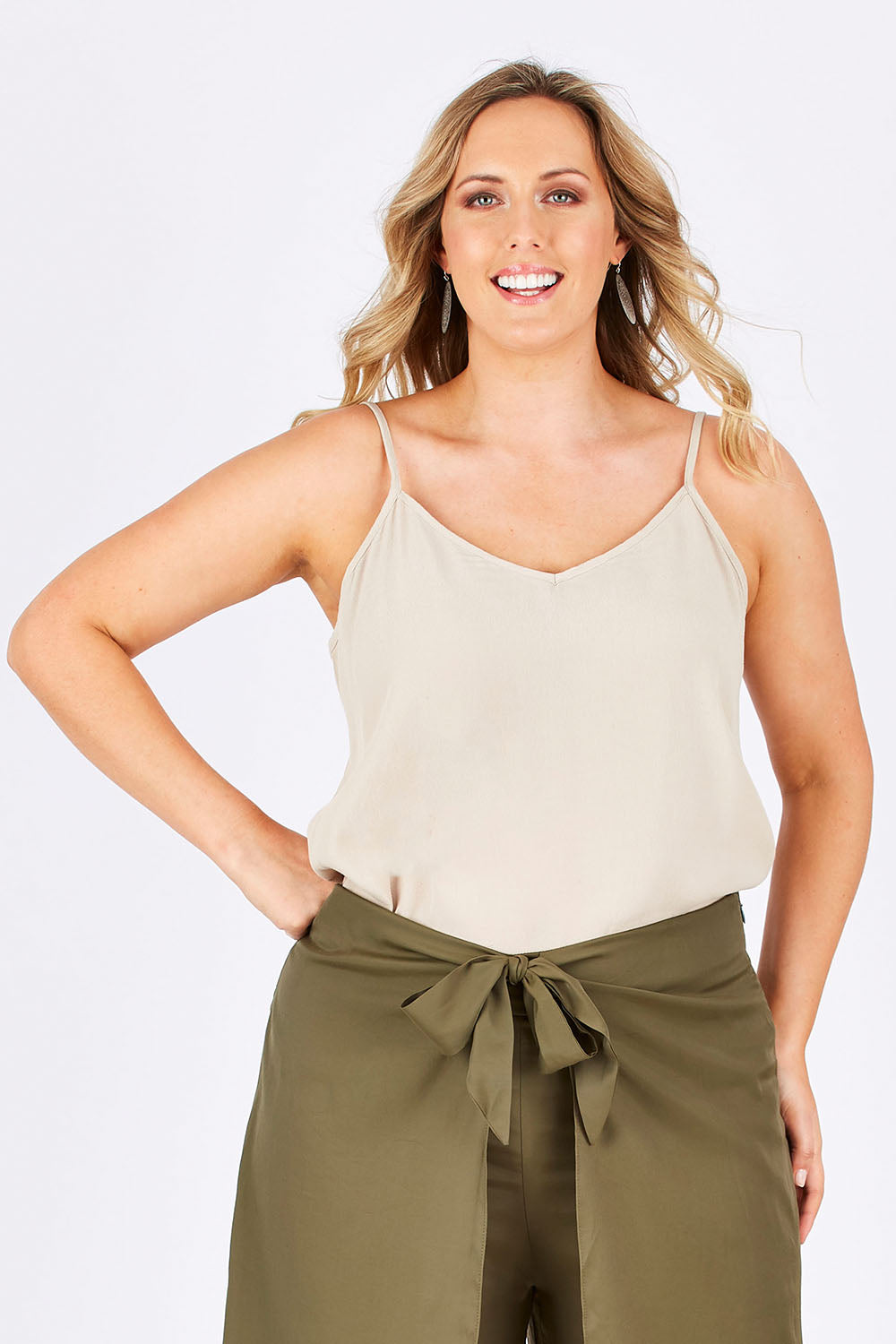Model Jess wearing size 14 of the Runaway Top in colour Sand, from the front, cropped image
