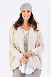 Model Georgia wearing size S of the Yeye Slouch Jumper in colour Sandy, from the front, cropped image