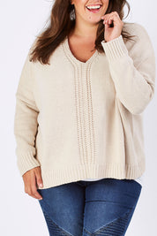 Model Mae wearing size XL of the Yeye Slouch Jumper in colour Sandy, from the front, cropped image
