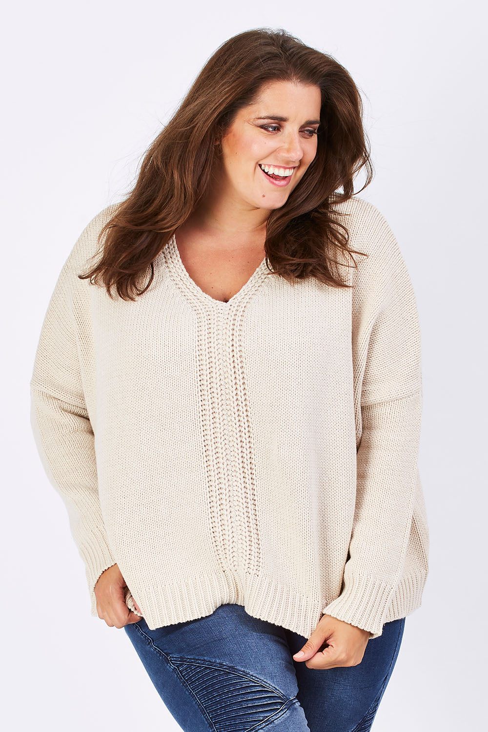 Model Mae wearing size XL of the Yeye Slouch Jumper in colour Sandy, from the front, cropped image