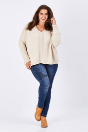 Model Mae wearing size XL of the Yeye Slouch Jumper in colour Sandy, from the front, showing the whole outfit