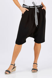 Model Georgia wearing size 10 of the Moped Cruising Shorts in colour Black (Black), from the front, cropped image