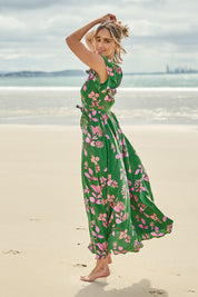 Model Tegan wearing size 10 of the Bellezza Maxi Dress in colour Pinkfleur (Green), from the front, showing the whole outfit