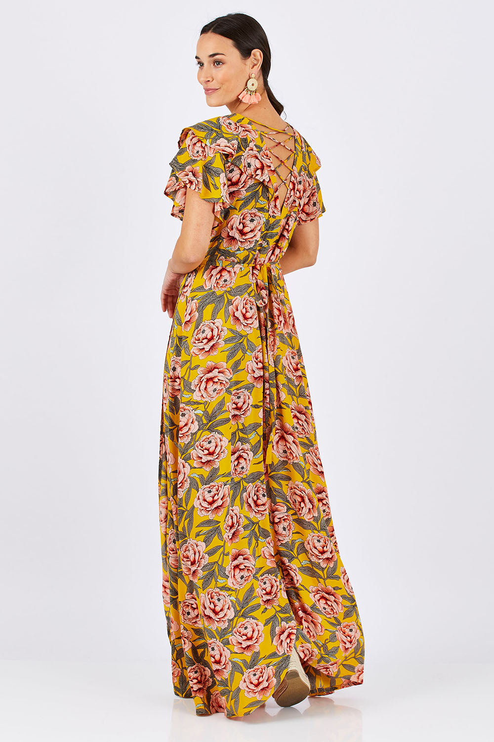Model Georgia wearing size 10 of the Bellezza Maxi Dress in colour Sunset, from the back