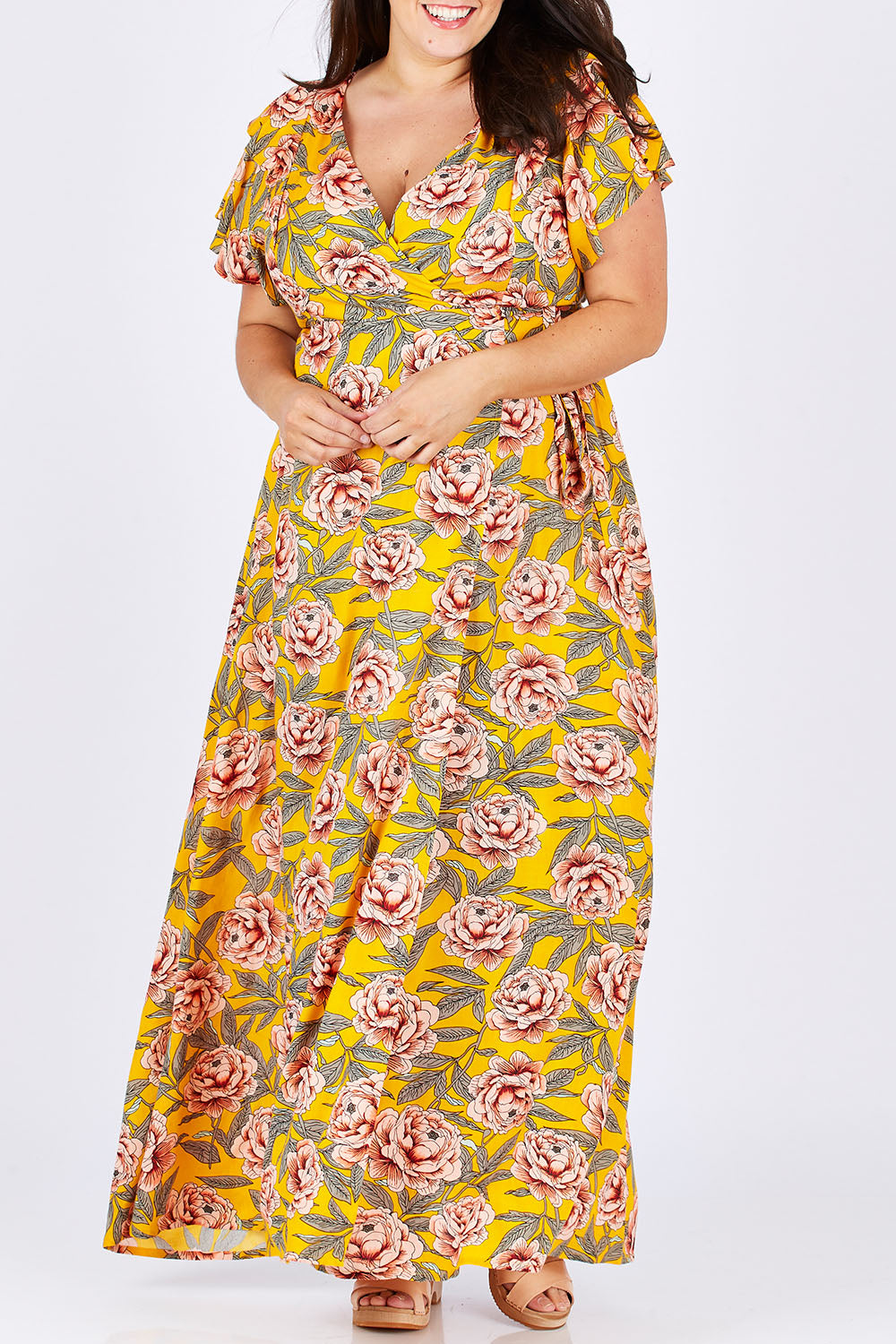 Model Mae wearing size 18 of the Bellezza Maxi Dress in colour Sunset, from the front, cropped image