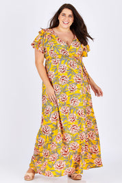 Model Mae wearing size 18 of the Bellezza Maxi Dress in colour Sunset, from the front, showing the whole outfit