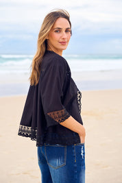 Model Tegan wearing size 10 of the Spring Day Cotton Throw in colour Black (Black), from the front, showing the whole outfit