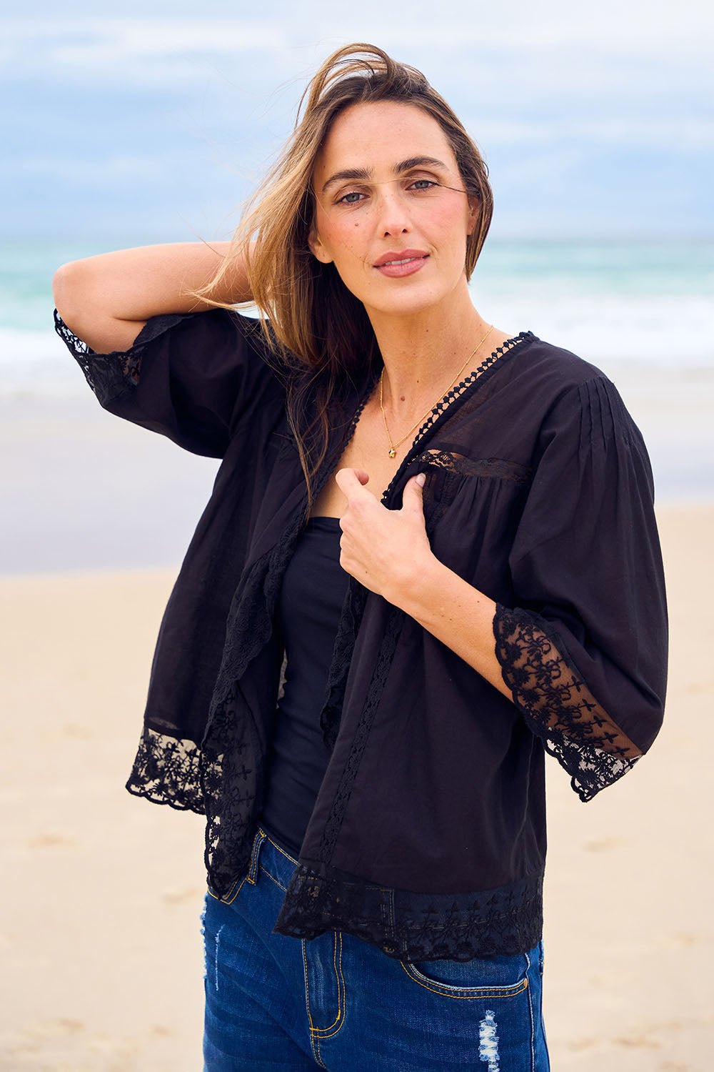 Model Tegan wearing the Spring Day Cotton Throw in colour Black (Black), from the front, showing the whole outfit
