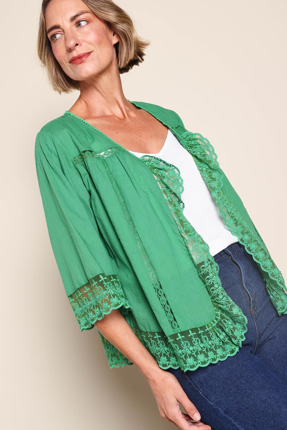 Model Riinar wearing size 10 of the Spring Day Cotton Throw – Green in colour Green, from an angle