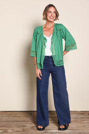 Model Riinar wearing size 10 of the Spring Day Throw – Green in colour Green, from the front