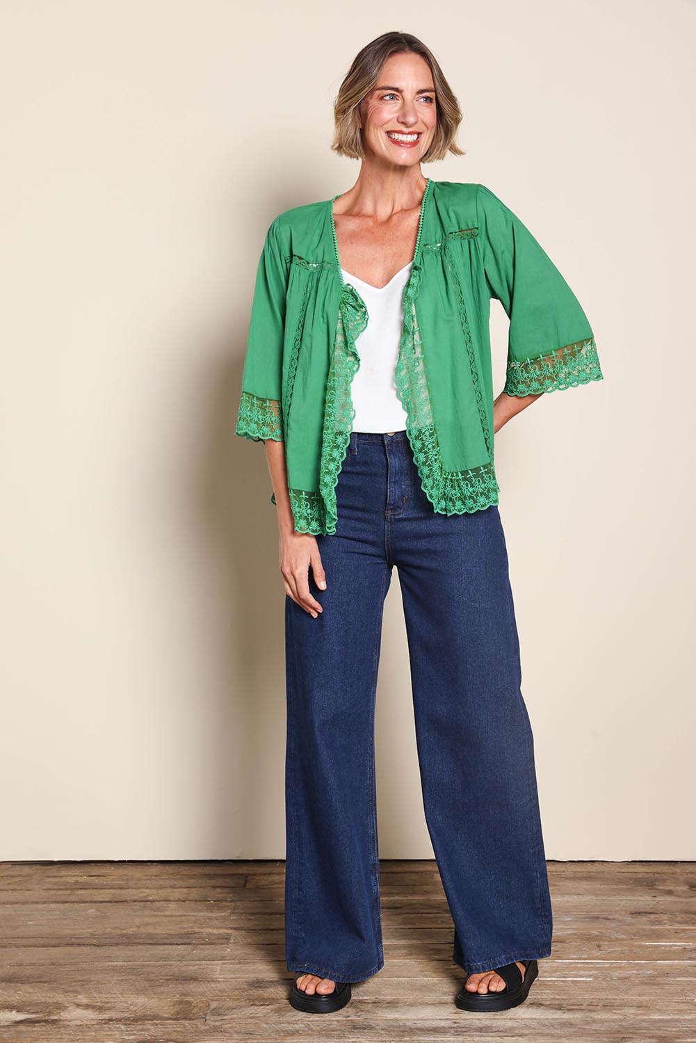 Model Riinar wearing size 10 of the Spring Day Cotton Throw – Green in colour Green, from the front