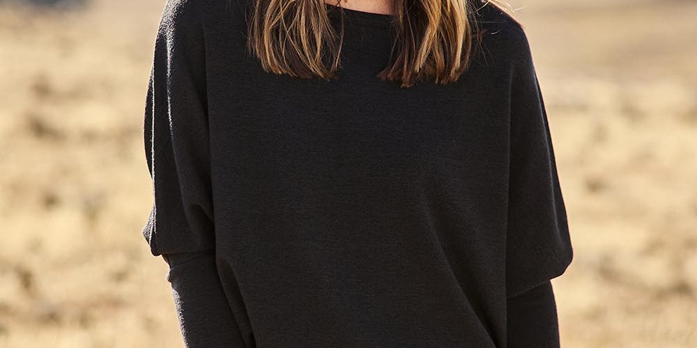 Model Nat wearing size 10 of the Snuggle Up Jumper in colour Black (Black), from the front, showing the whole outfit