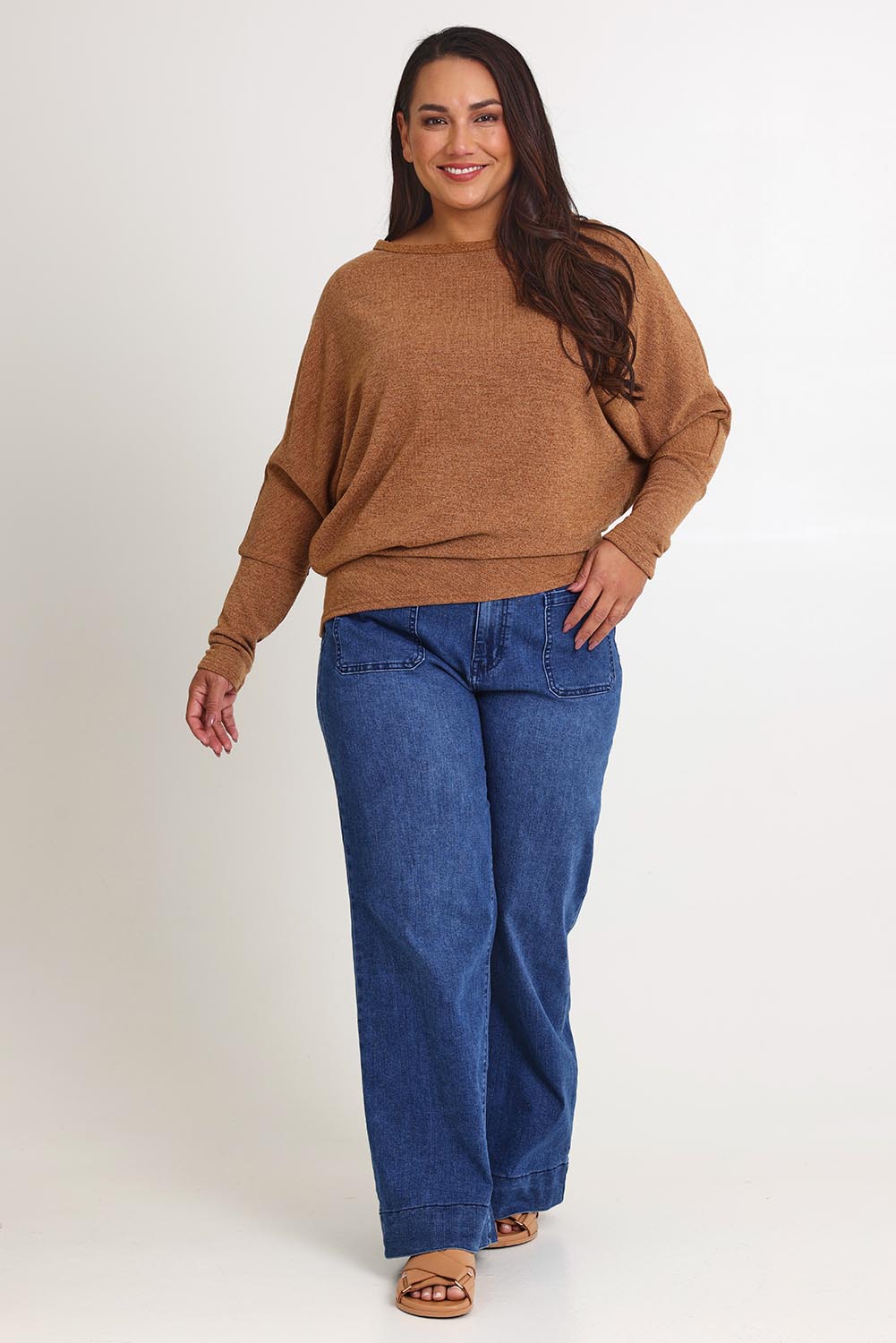 Model Ashleigh wearing size 16 of the Snuggle Up Jumper in colour Coffee, from the front, showing the whole outfit