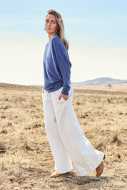 Model Tegan wearing size 10 of the Snuggle Up Jumper in colour Indigo (Blue), from the front, showing the whole outfit