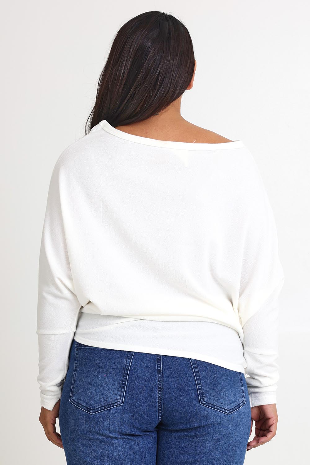 Model Ashleigh wearing size 16 of the Snuggle Up Jumper in colour Ivory (White), from the back
