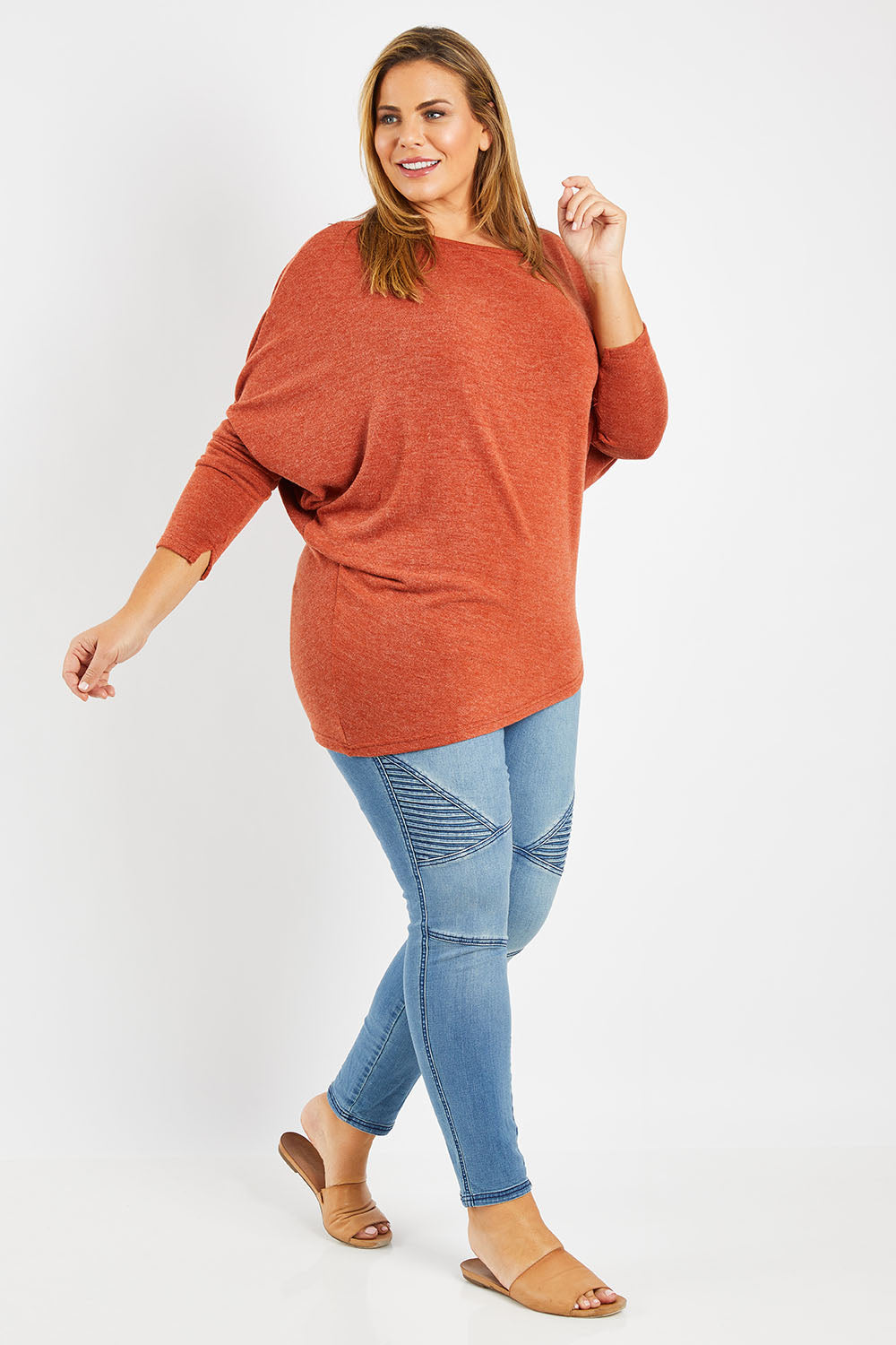 Model Fiona wearing size 16 of the Snuggle Up Jumper in colour Rust, from the front, showing the whole outfit