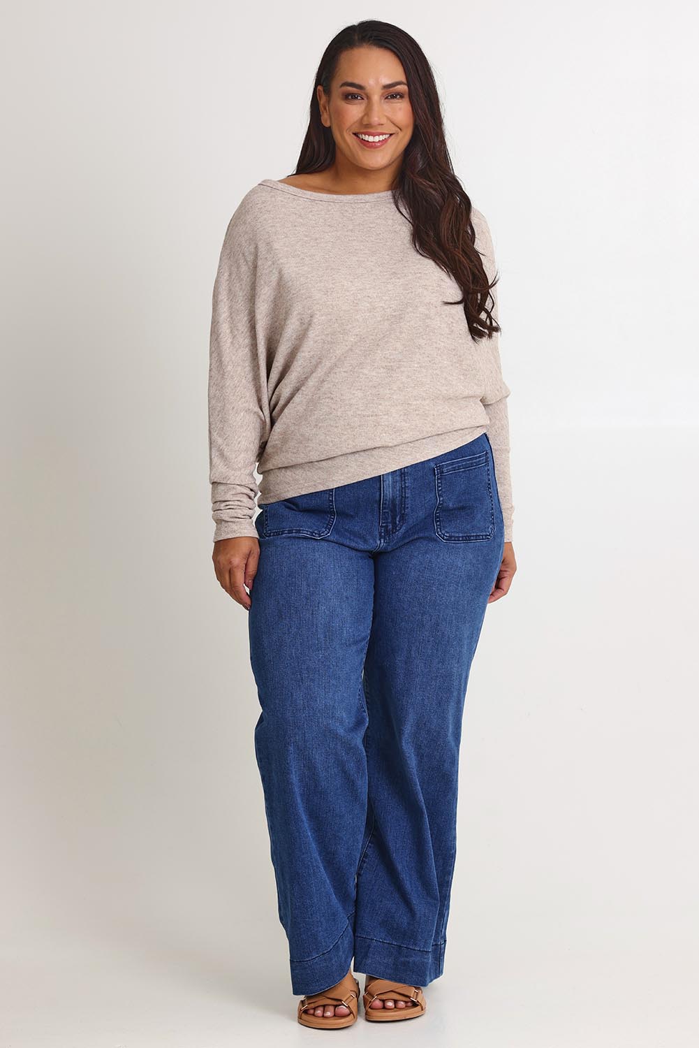 Model Ashleigh wearing size 16 of the Snuggle Up Jumper in colour Sandmarl, from the front, showing the whole outfit