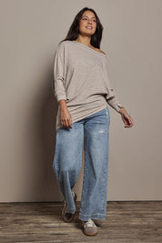Model Tahnee wearing size 10 of the Snuggle Up Jumper in colour Sandmarl, from the front, showing the whole outfit