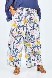 Model Palatina wearing size 14 of the Flowers For Me Pants in colour Flowerfall (Blue), from the front, cropped image