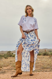 Model Tegan wearing size 10 of the Skirting Around The Garden Skirt in colour Whitehorse (White), from the front, showing the whole outfit
