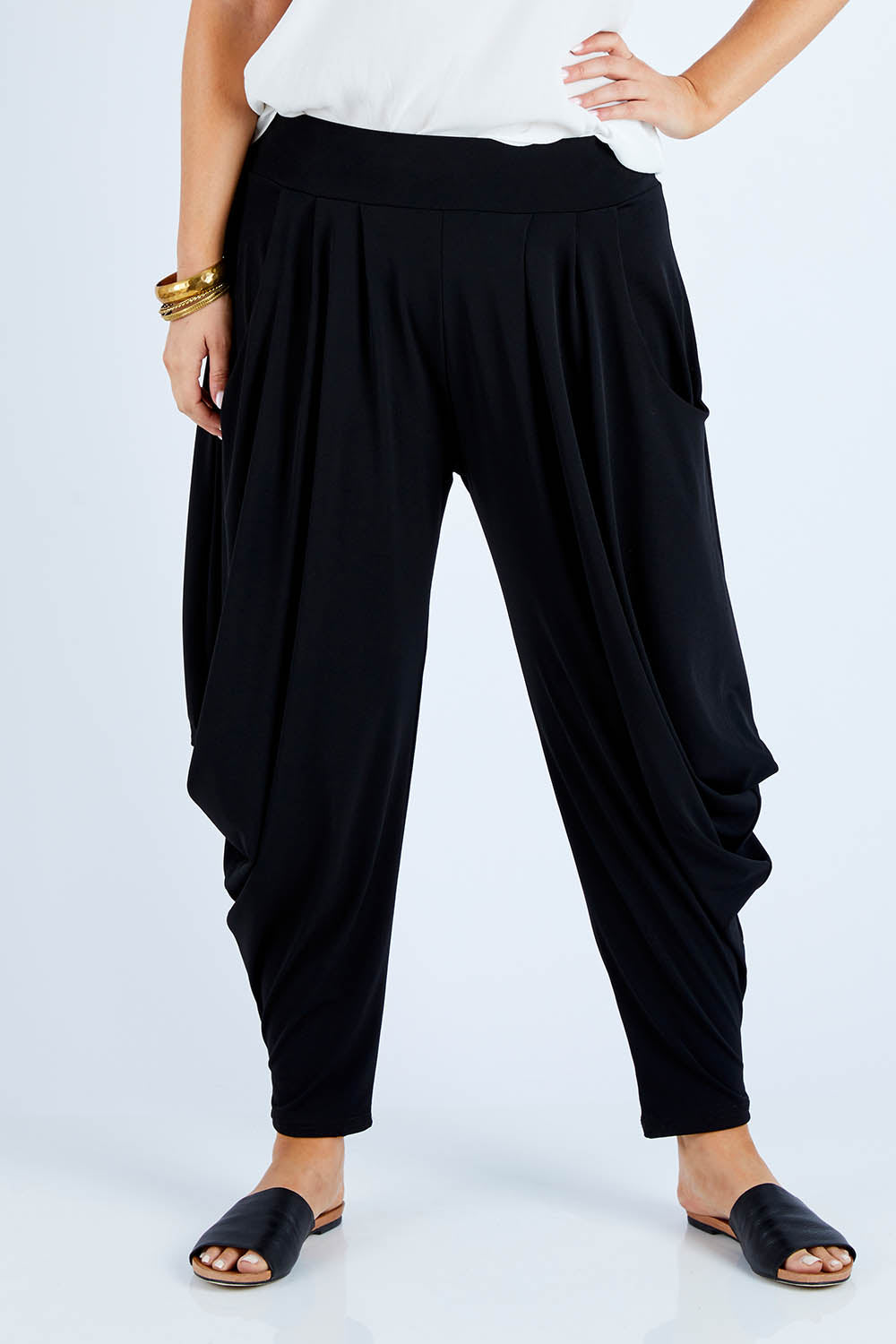 Model Jess wearing size 14 of The Wanderer In Me Travel Pant in colour Black (Black), from the front, cropped image