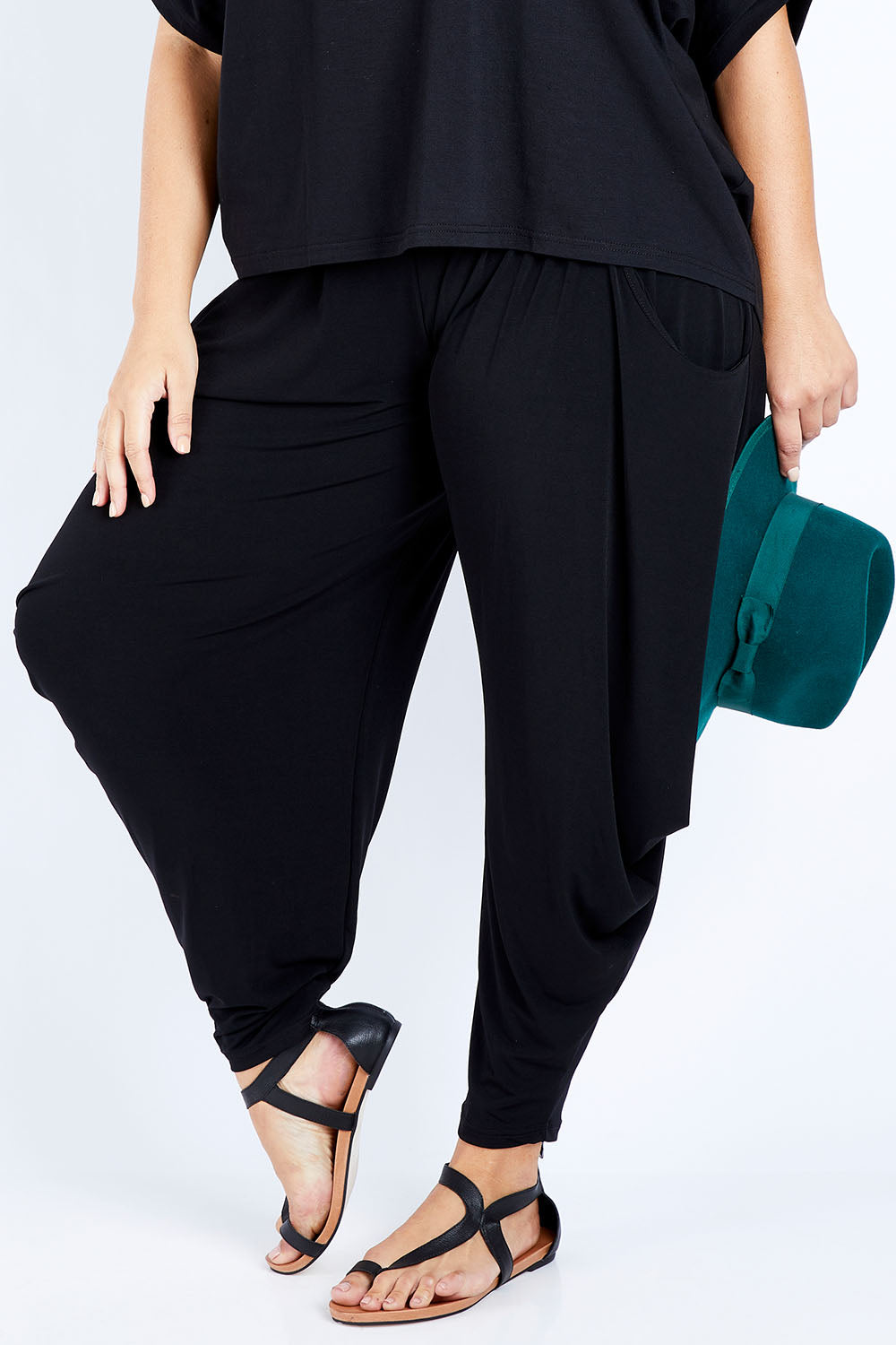 Model Jess wearing size 16 of The Wanderer In Me Travel Pant in colour Black (Black), from the front, cropped image