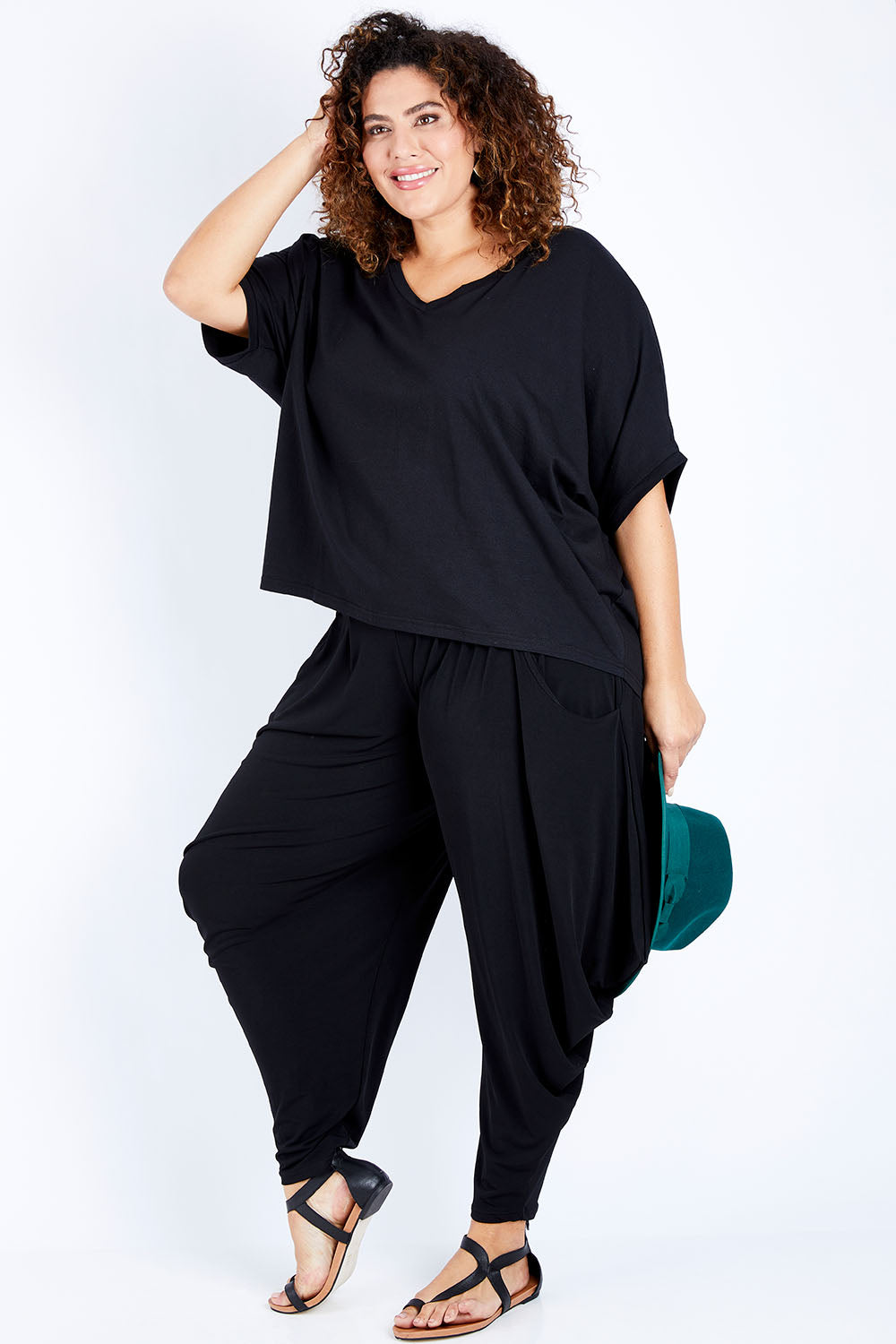 Model Jess wearing size 16 of The Wanderer In Me Travel Pant in colour Black (Black), from the front, showing the whole outfit
