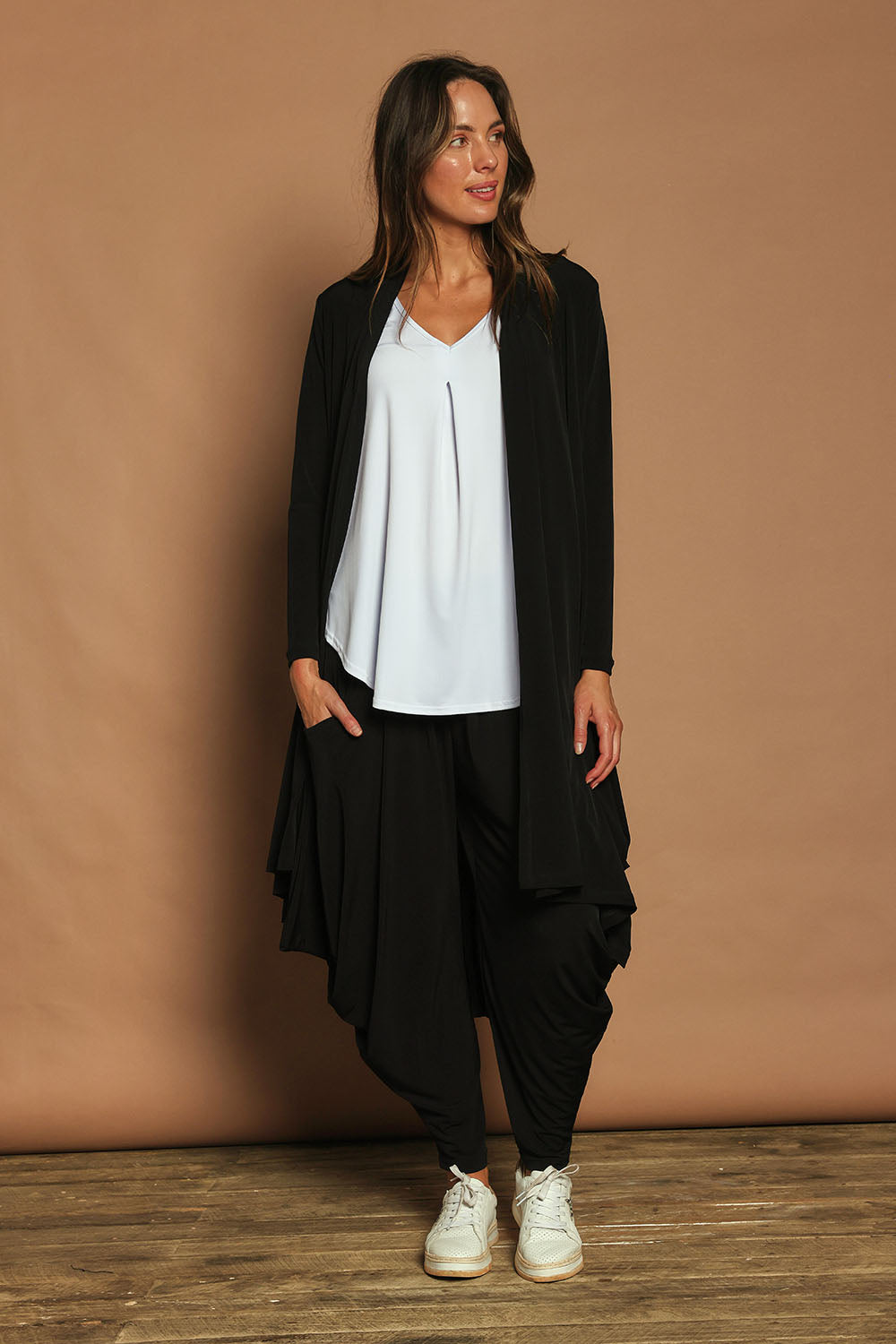 Model Madeline wearing size 10 of The Wanderer In Me Travel Pant in colour Black (Black), from the front, showing the whole outfit