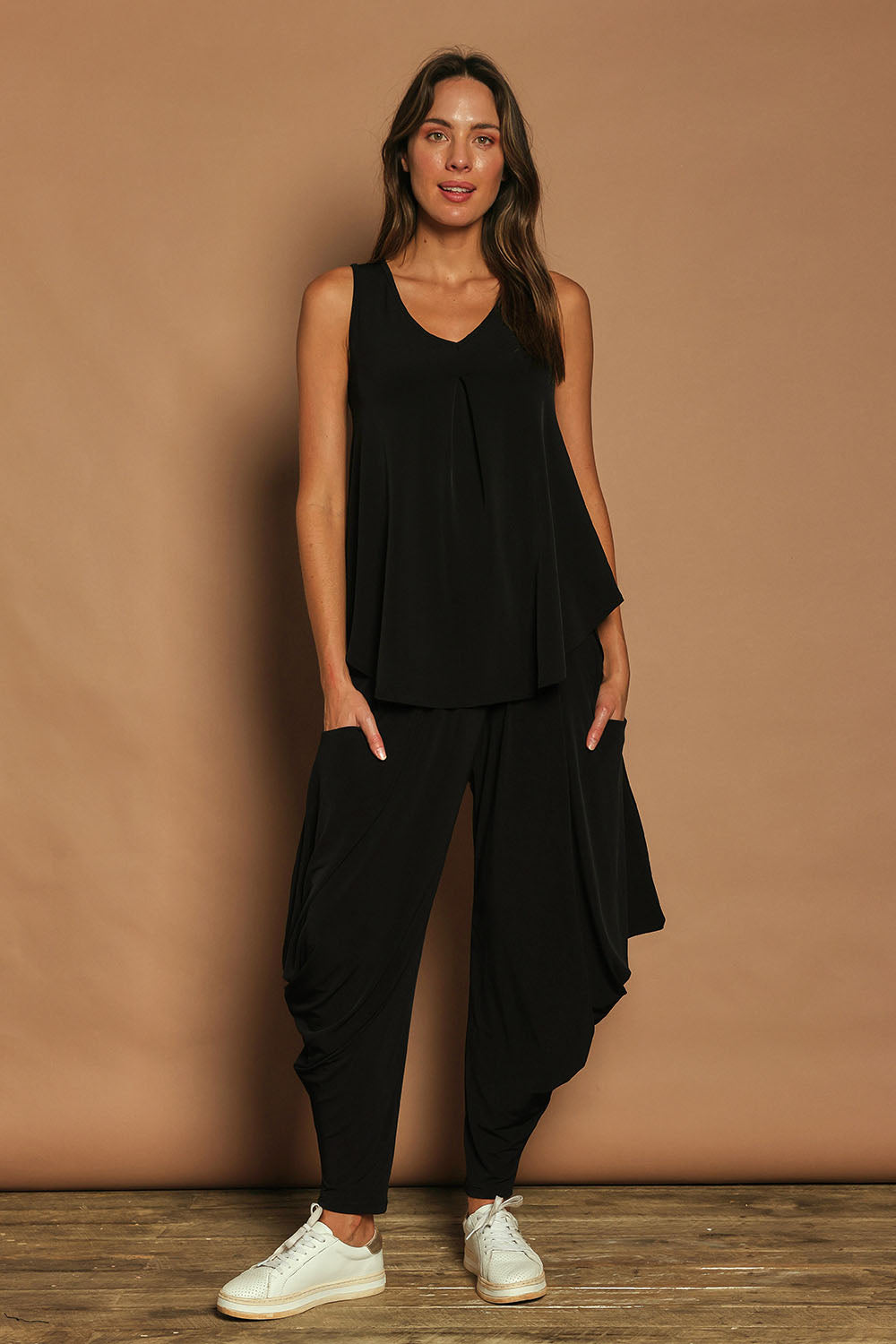 Model Madeline wearing size 10 of The Wanderer In Me Travel Pant in colour Black (Black), from the front, showing the whole outfit