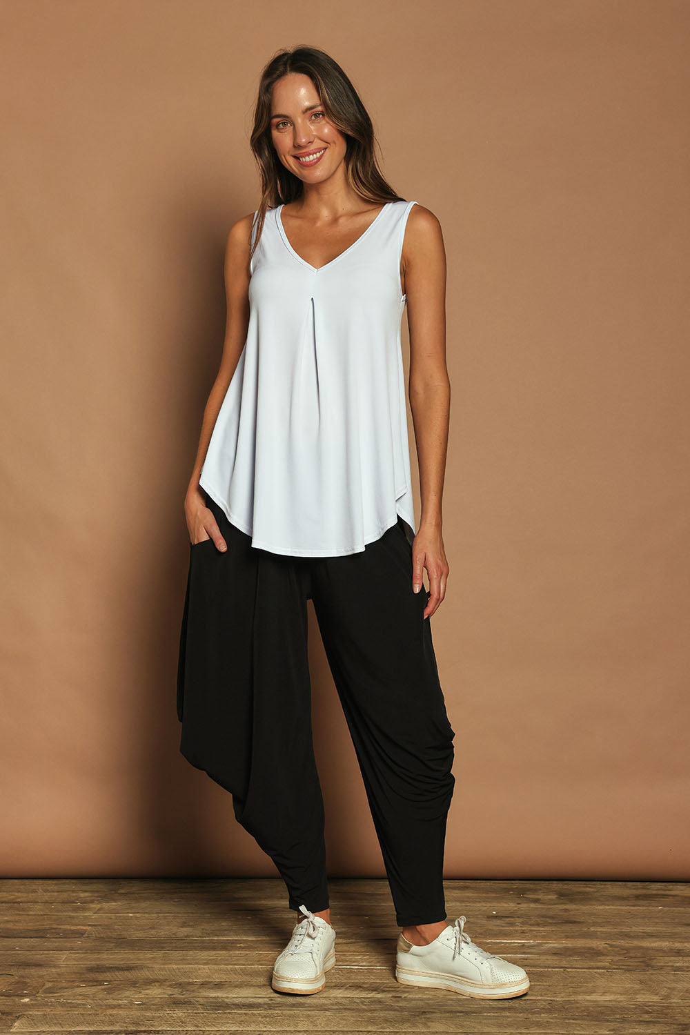 Model Madeline wearing size 10 of The Wanderer In Me Travel Pant in colour Black (Black), from the front, showing the whole outfit
