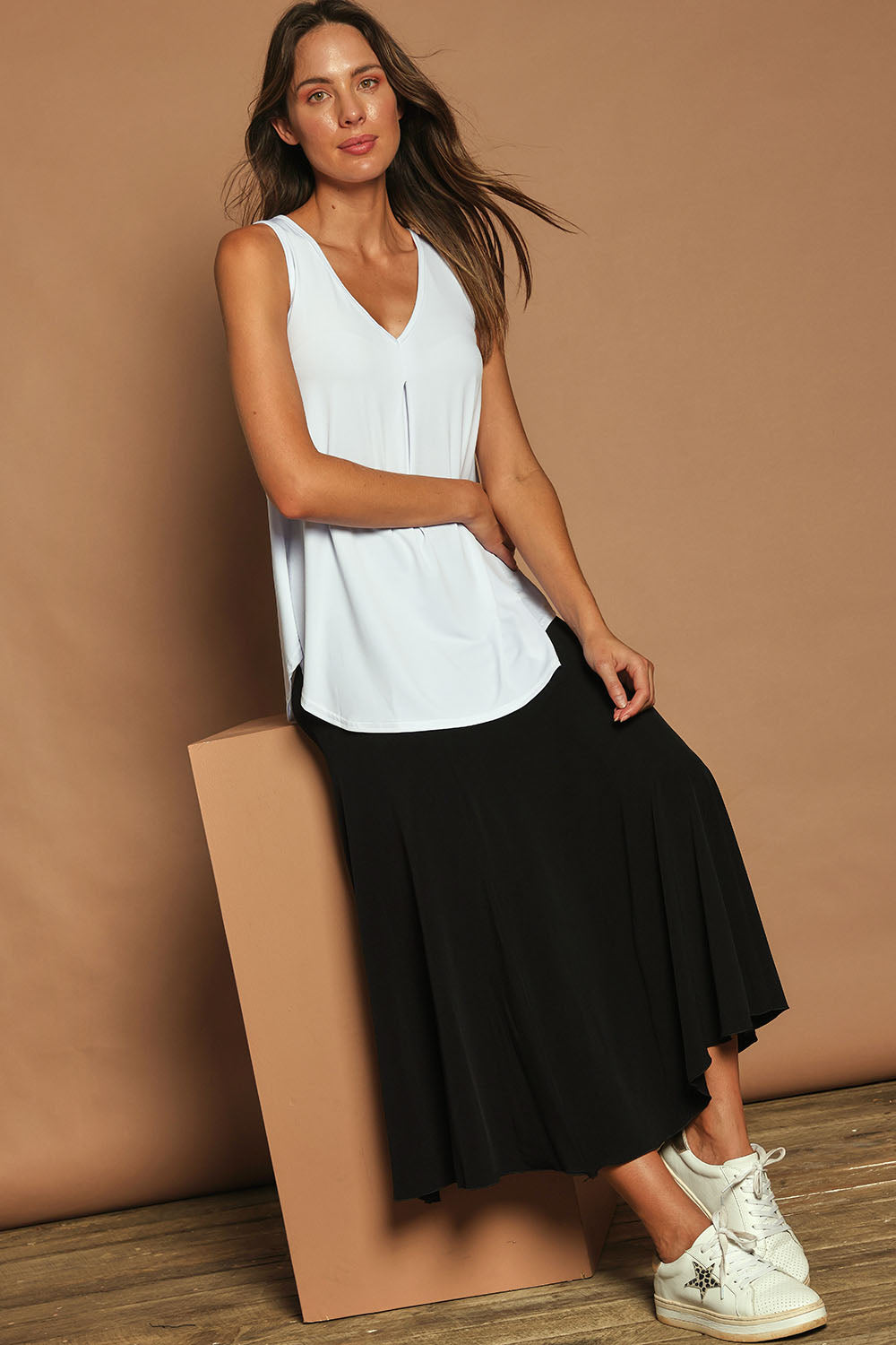 Model Madeline wearing size 10 of The Wanderer In Me Travel Skirt in colour Black (Black), from the front, showing the whole outfit