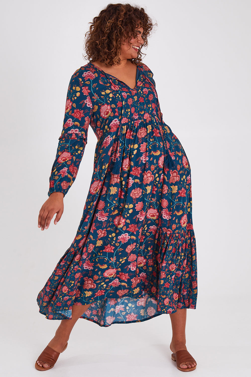 Model Anucia wearing size 14 of the Its Better With You Dress in colour Tealfleur (Blue), from the front, showing the whole outfit