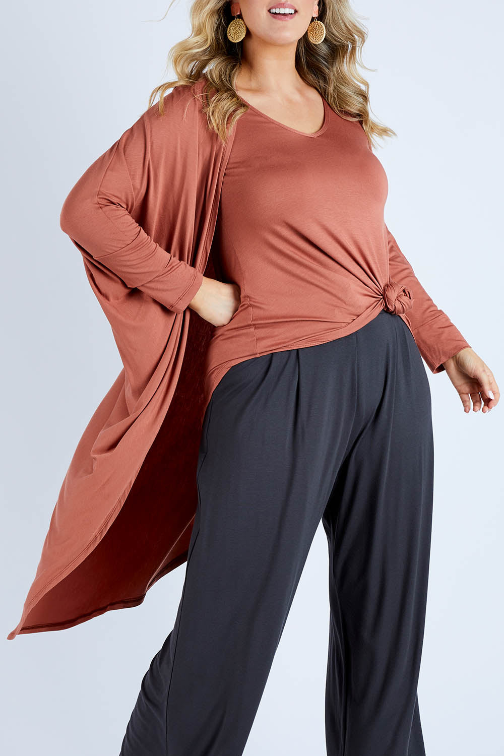 Model Jess wearing size 14 of the Falling For You Bamboo Cardi in colour Copper, from the front, cropped image