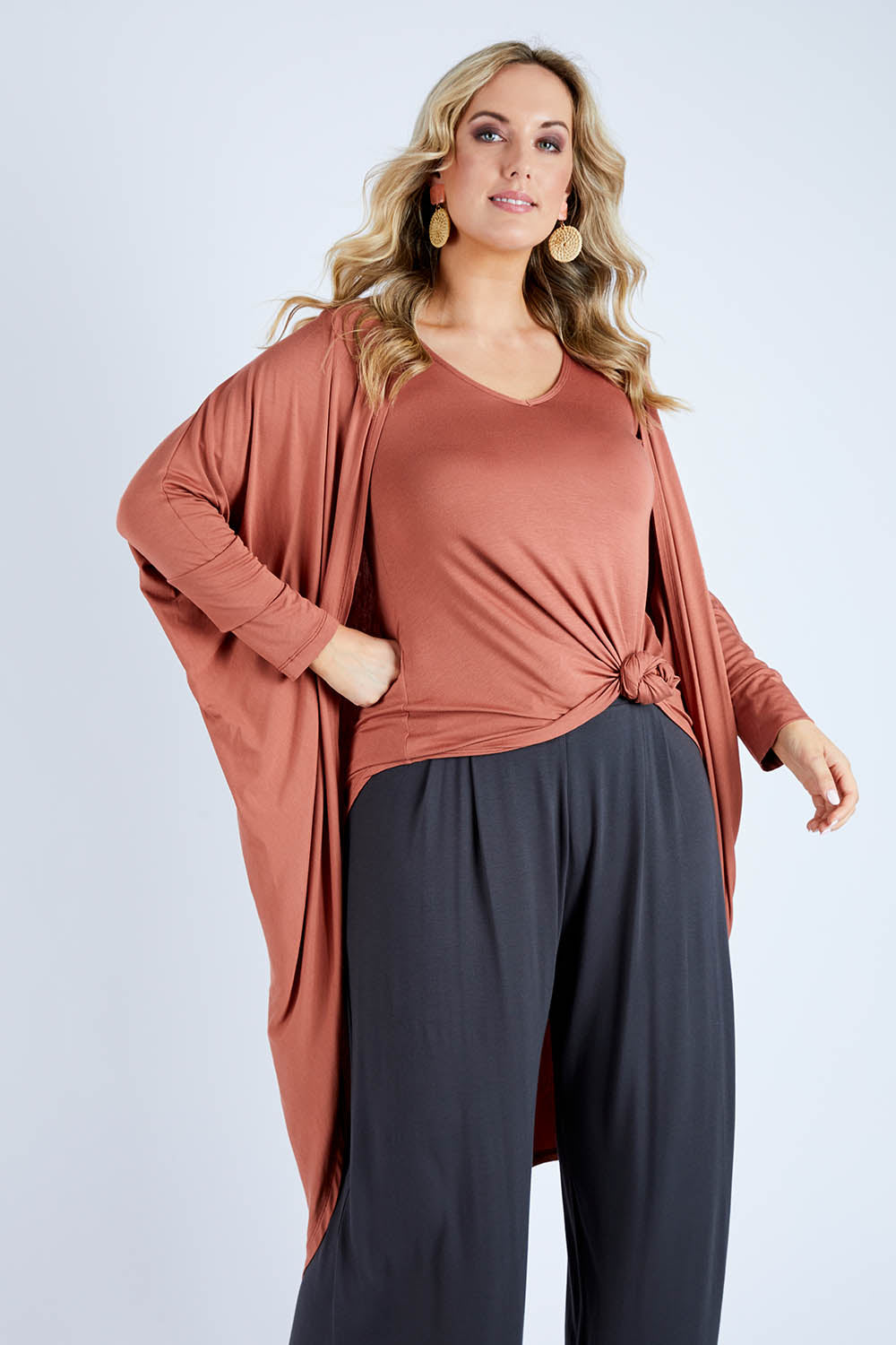 Model Jess wearing size 14 of the Falling For You Bamboo Cardi in colour Copper, from the front, cropped image