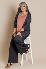 Model Nadine wearing size 10 of the Falling For You Bamboo Cardi in colour Storm (Black), from the front, showing the whole outfit
