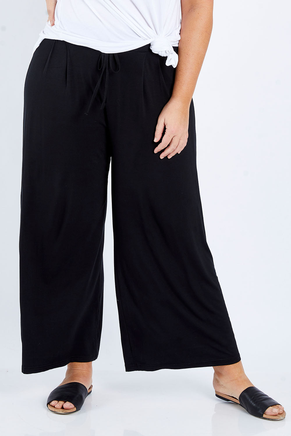 Model Fiona wearing size 16 of the Softly Swinging Bamboo Pants in colour Black (Black), from the front, cropped image