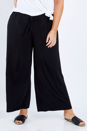Model Fiona wearing size 16 of the Softly Swinging Bamboo Pants in colour Black (Black), from the front, cropped image