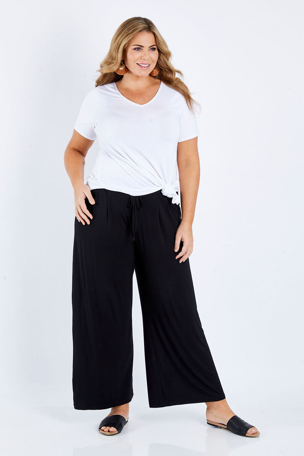 Model Fiona wearing size 16 of the Softly Swinging Bamboo Pants in colour Black (Black), from the front, showing the whole outfit