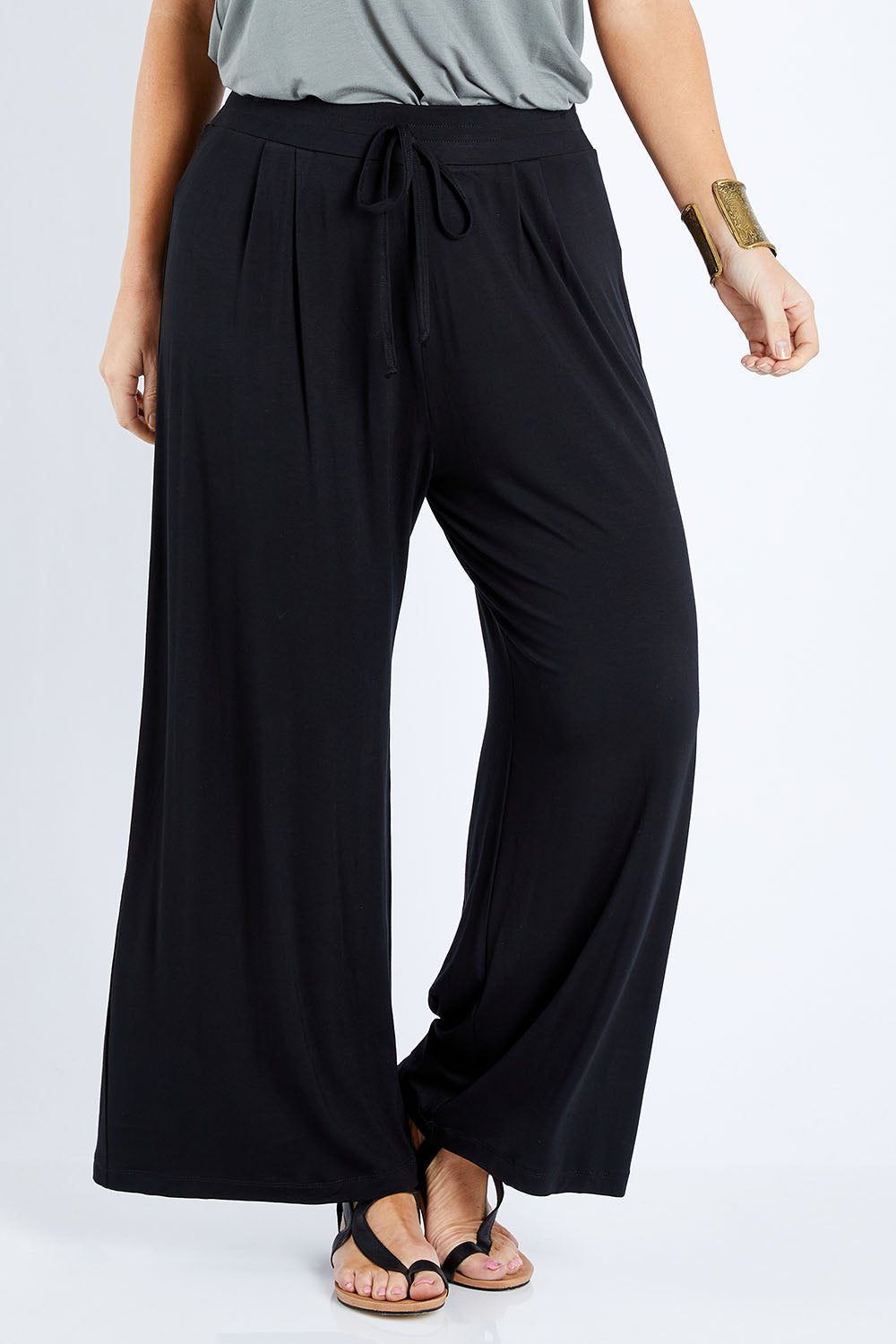 Model Laura wearing size 12 of the Softly Swinging Bamboo Pants in colour Black (Black), from the front, cropped image