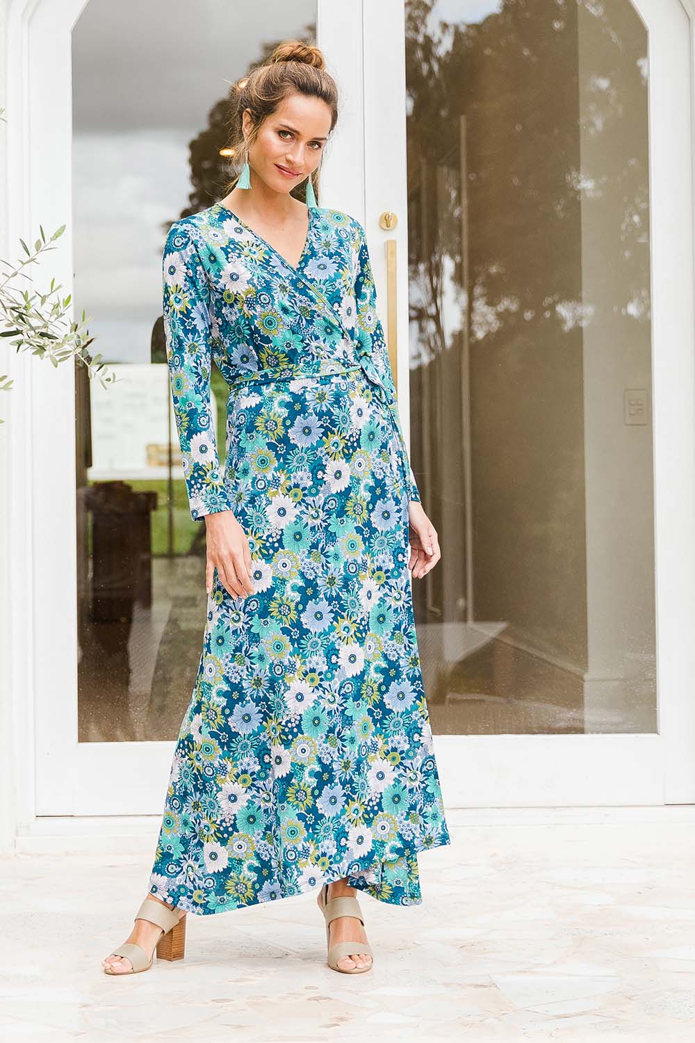 Model Ilona wearing size 10 of the Life Is Beautiful Wrap Maxi Dress in colour Bluefleur (Blue), from the front, showing the whole outfit