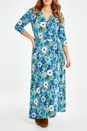 Model Laura wearing size 14 of the Life Is Beautiful Wrap Maxi Dress in colour Bluefleur (Blue), from the front, cropped image