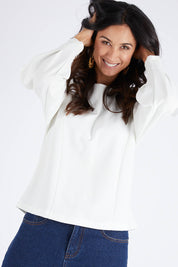 Model Gemma wearing size 10 of the Its All In The Sleeve Top in colour Ivory (White), from the front, cropped image