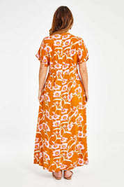 Model Laura wearing size 14 of the Wild Garden Maxi Dress in colour Caramel, from the back