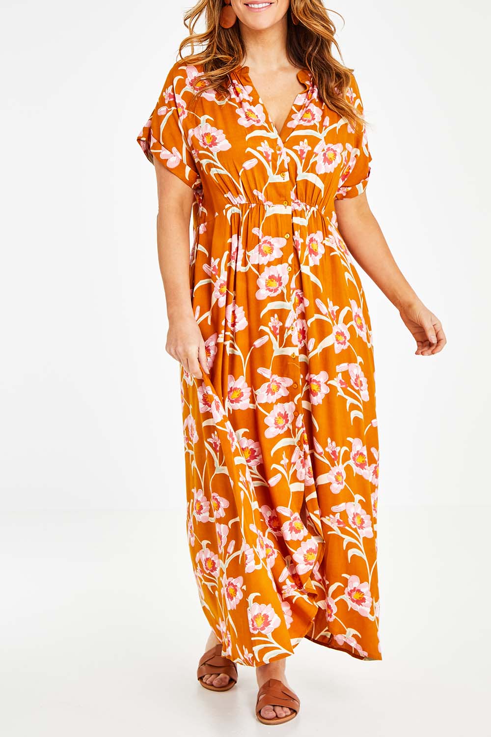 Model Laura wearing size 14 of the Wild Garden Maxi Dress in colour Caramel, from the front, cropped image