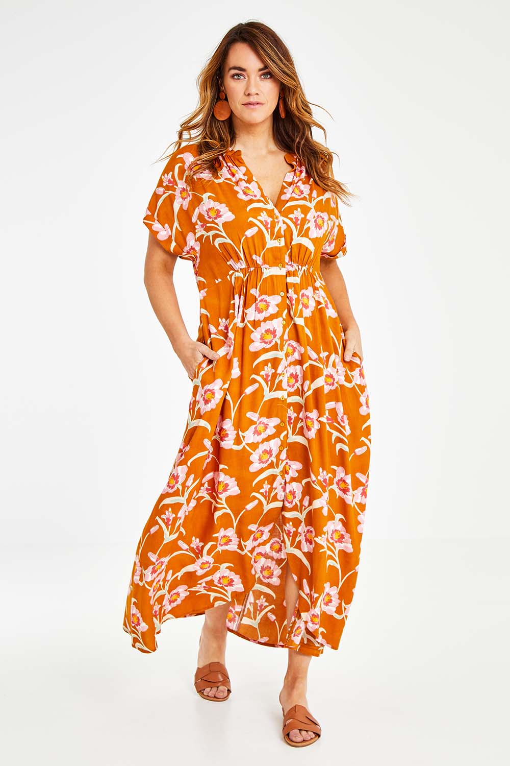 Model Laura wearing size 14 of the Wild Garden Maxi Dress in colour Caramel, from the front, showing the whole outfit
